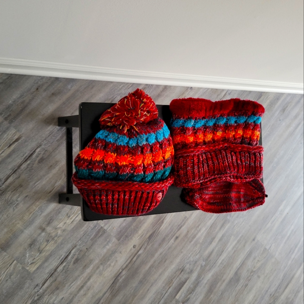 Winter hat with scarf and face covering in colors red blue and rust.